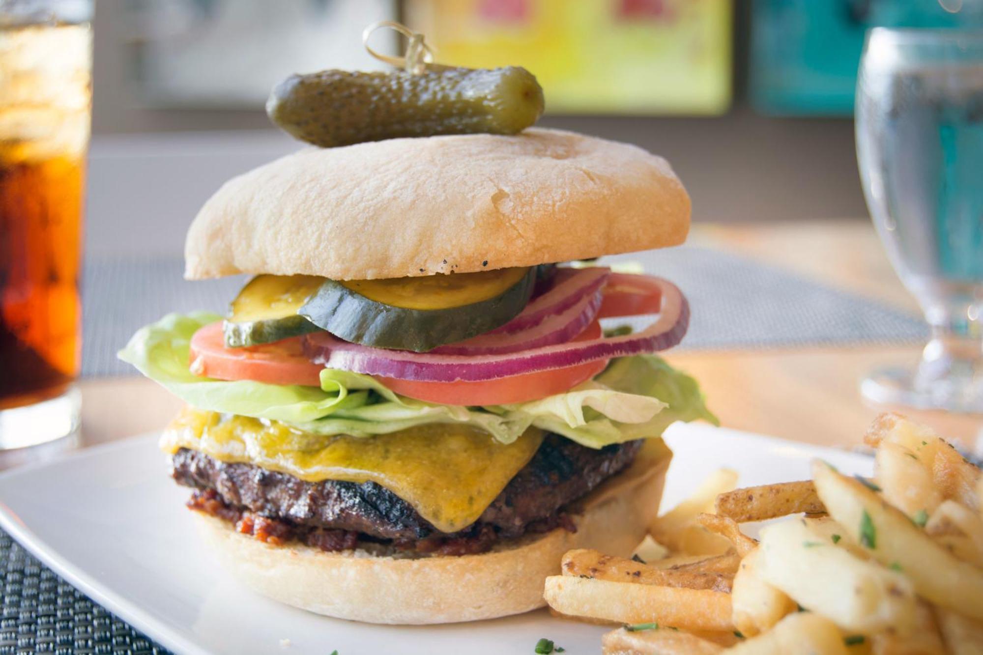 Hotel Murano Tacoma Bagian luar foto A cheeseburger with lettuce, tomato, onion, and pickle